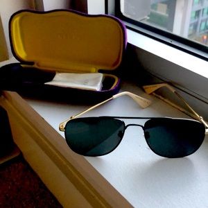 Gucci black aviator lenses. Black frames and gold ear clasps.